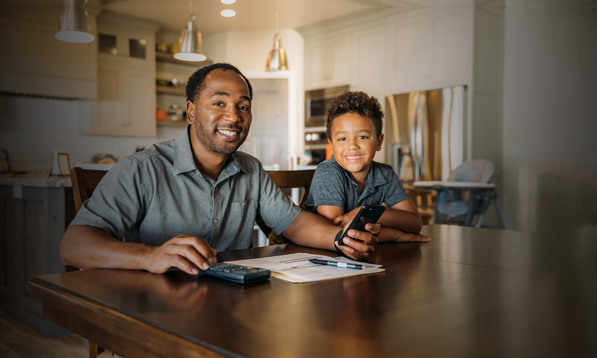 Man and boy sitting at table